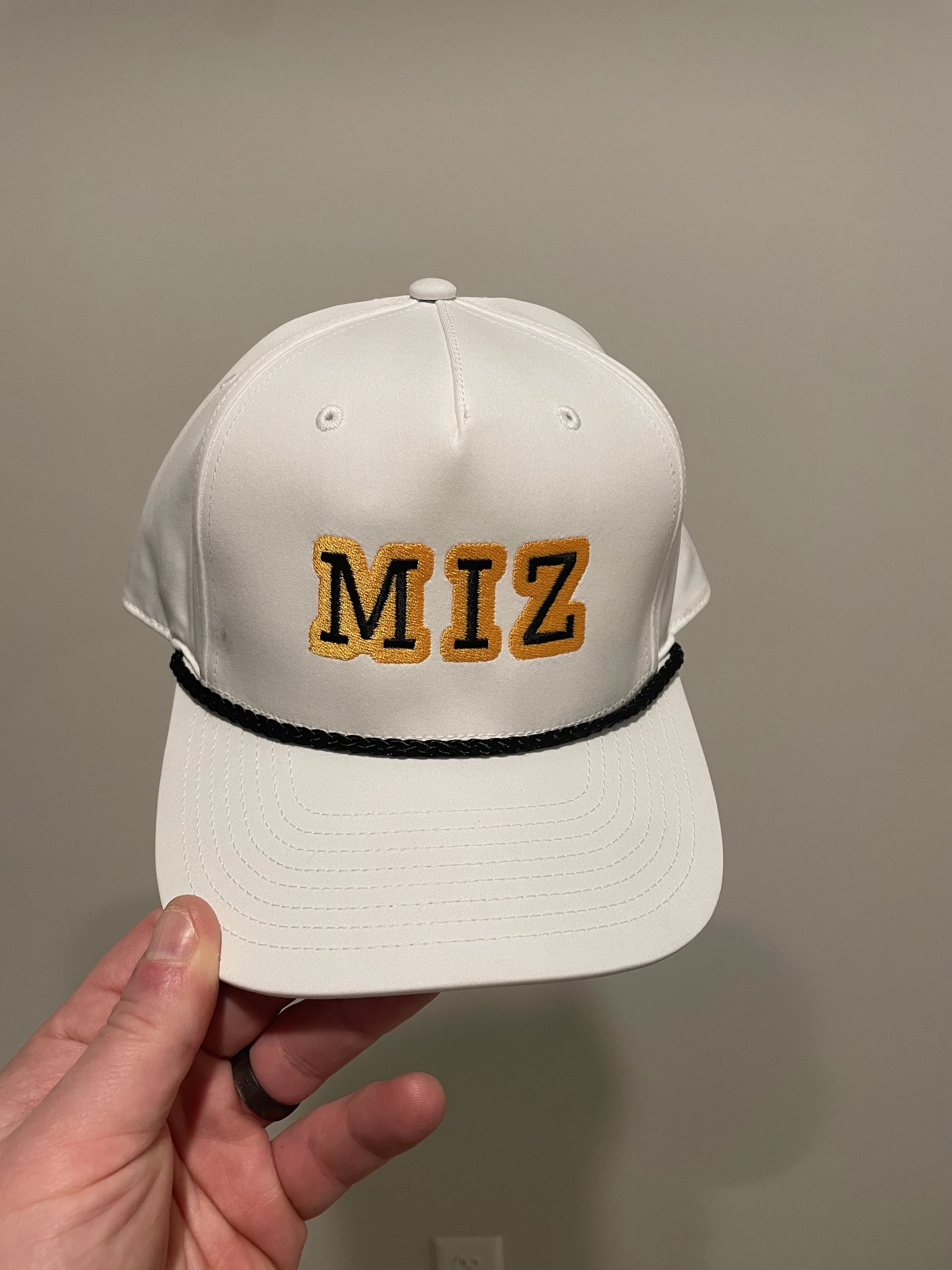 white gold and black rope hat